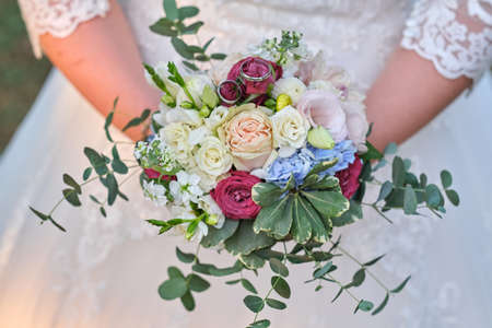 Bride holds a wedding bouquet, wedding dress, wedding detailsの写真素材