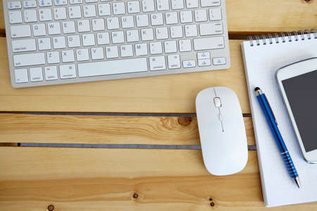 Office desk table with computer, supplies and smarthphoneの写真素材