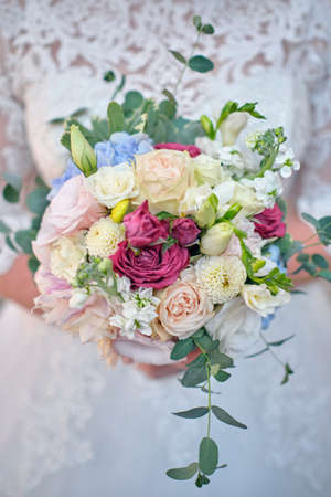 Bride holds a wedding bouquet, wedding dress, wedding detailsの写真素材