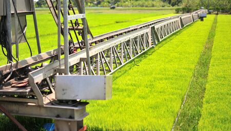Machine is pouring water to wheat grass farm in Thailand.の写真素材
