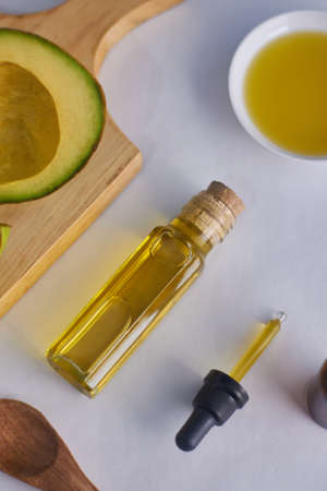 avocado oil in glass bottle with white background