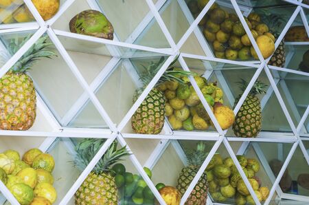 shelf full of fresh tropical fruits to make juiceの写真素材