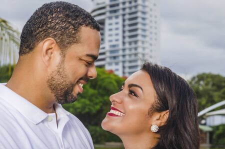 couple of Latin American men and women, with boy suffers autism, happy in a portrait family outdoors...