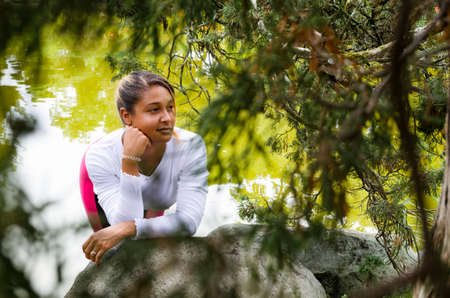 young woman 20-25 years old in sportswear in a park, looking at camera