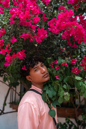 Portrait of an attractive and stylish fashionable young Latin American non-binary teenage girl, confident and happy with her gender identity, outdoorsの写真素材