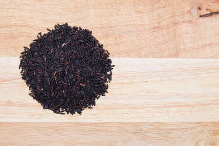 Rice berry on wooden backgroundの写真素材