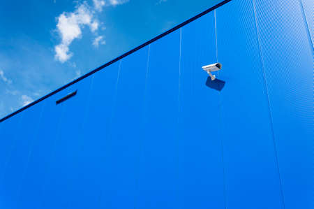 CCTV camera. Security camera on the blue wall. Private property protection.の写真素材