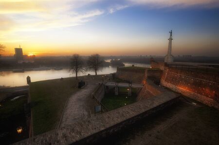 Medieval Fortress in Misty Winter Orange sunset, Belgrade, Serbiaの写真素材