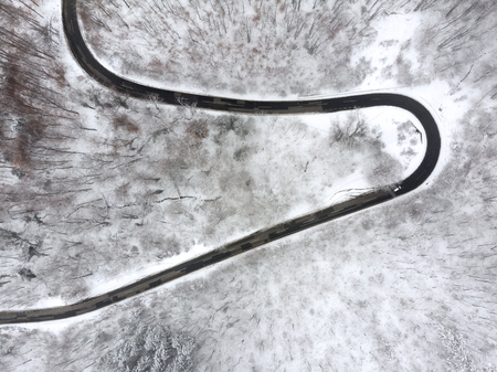 Winter Mountain Forest Aerial Shot, Woods Covered with Snow and Fog. Cold January morning.