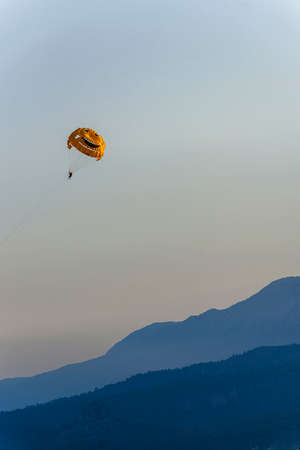 Smiling Parachute, Parasailing against the background of the mountain ridge  near Kemer, in Turkey.