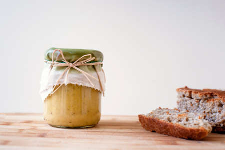Hummus in a jar on wooden table