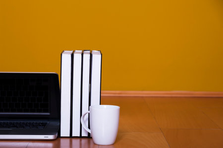 Back to school concept, laptop books coffee mug on wooden floorの写真素材