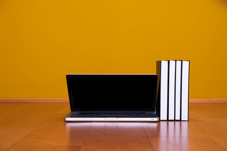Back to school concept, laptop books coffee mug on wooden floor