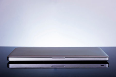 Back to school concept, laptop on reflective surfaceの写真素材