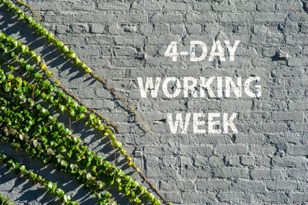4 - Day working week on a brick wall with green leaves symbolizing nature taking over urban life.の写真素材
