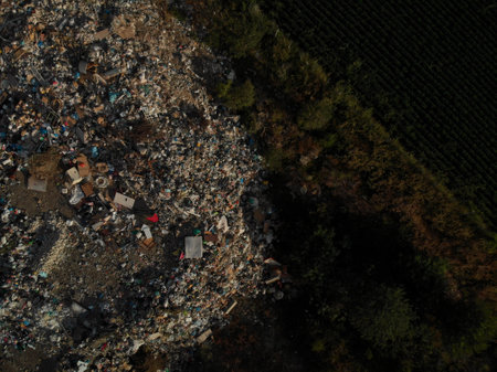 Aerial drone point of view of a commercial landfill garbage dump, land and environmental polution conceptの写真素材