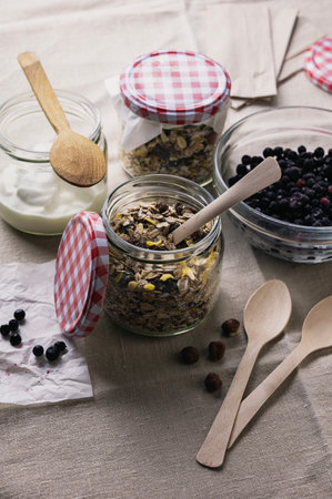 Oatmeal for healthy breakfast in glass jar, prepared earlier with yogurt and blackberries, breakfast to go conceptの写真素材