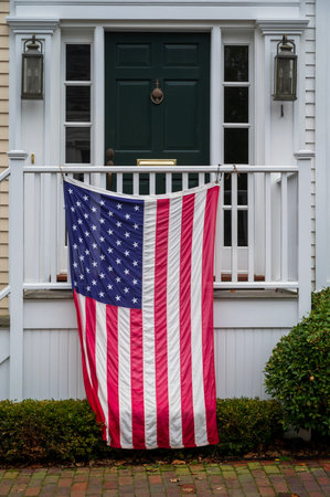American flag on house porch or window, celebrating Independance day in the United States. Proud patriot theme.の写真素材