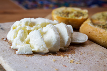 Mozzarella and garlic Bread on wooden plate for traditional mediterranean breakfast, healthy...