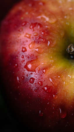 A red apple with waterdrops, close up