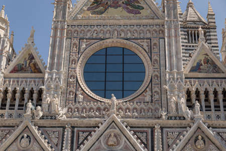 Mosaic And Circular Window on the Facade of Siena Cathedral, Siena, Italy