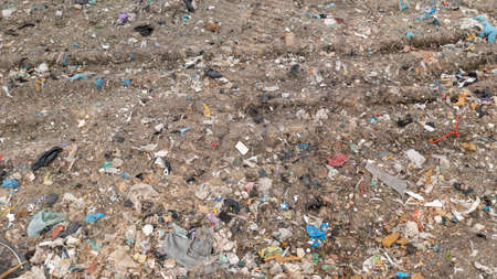 Stack of different types of large garbage dump, plastic bags, and trash bins