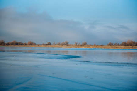Not completely frozen river in winter. Half the river is frozen
