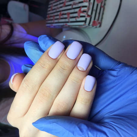 blue female manicure on nails close up in the photo