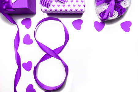 March 8 International Womens Day concept. Number 8 from purple ribbon and purple gift box on white...