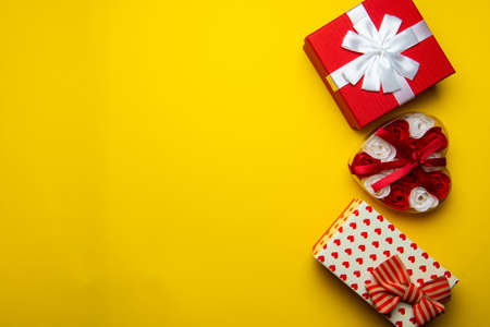 Red gift boxes on a yellow background.Flat lay,copy space.Gift and holidays concept with copy space