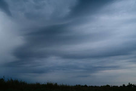 Green meadow under blue sky with cloudsの写真素材