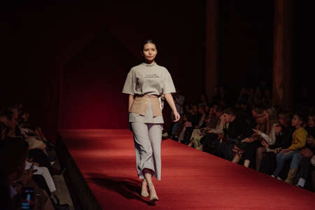 ASTRAKHAN RUSSIA - NOVEMBER 01, 2019. Caspian Fashion Week.A woman model walks the red runway.Fashion show,catwalk event,runway show.のeditorial素材