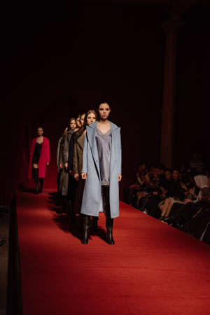 ASTRAKHAN RUSSIA - NOVEMBER 01, 2019. Caspian Fashion Week.A woman model walks the red runway.Fashion show,catwalk event,runway show.のeditorial素材