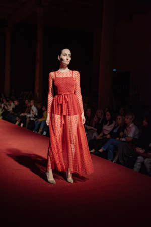 ASTRAKHAN RUSSIA - NOVEMBER 01, 2019. Caspian Fashion Week.A woman model walks the red runway.Fashion show,catwalk event,runway show.のeditorial素材