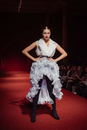 ASTRAKHAN RUSSIA - NOVEMBER 01, 2019. Caspian Fashion Week.A woman model walks the red runway.Fashion show,catwalk event,runway show.のeditorial素材