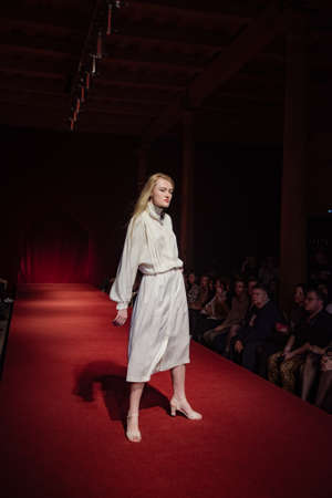 ASTRAKHAN RUSSIA - NOVEMBER 01, 2019. Caspian Fashion Week.A woman model walks the red runway.Fashion show,catwalk event,runway show.のeditorial素材