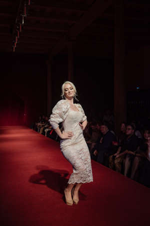 ASTRAKHAN RUSSIA - NOVEMBER 01, 2019. Caspian Fashion Week.A woman model walks the red runway.Fashion show,catwalk event,runway show.のeditorial素材