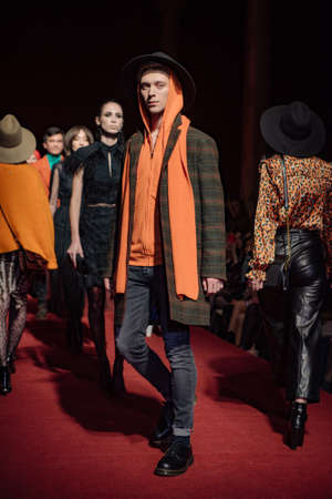 ASTRAKHAN RUSSIA - NOVEMBER 01, 2019. Caspian Fashion Week.A woman model walks the red runway.Fashion show,catwalk event,runway show.