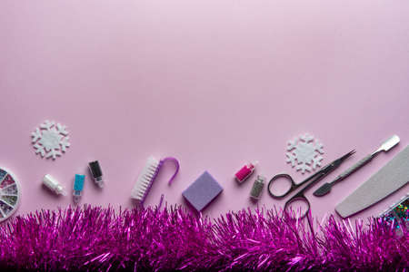 Beauty accessories for manicure and pedicure on a pink background,. Samples of nail polish, scissors and other accessories for home and salon proceduresの写真素材