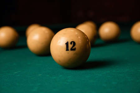 Yellow billiard balls on a green billiard table close upの写真素材