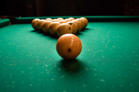 pyramid of billiard balls on the billiard table close up. Billiard balls pool in triangle on green tableの写真素材