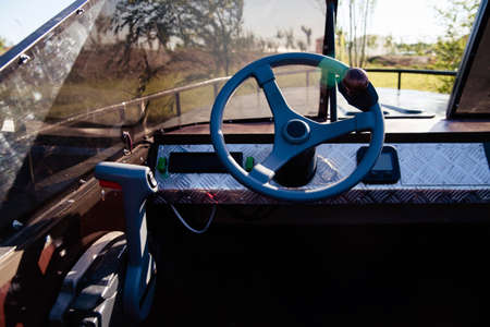 Motor boat steering wheel with throttle control in cockpit.Instrument panel and steering wheel of a motor boat cockpitの写真素材