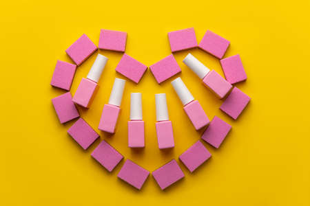 Nail manicure concept.Manicure accessories.Nail manicure buffs and varnishes of pink color in the form of heartの写真素材