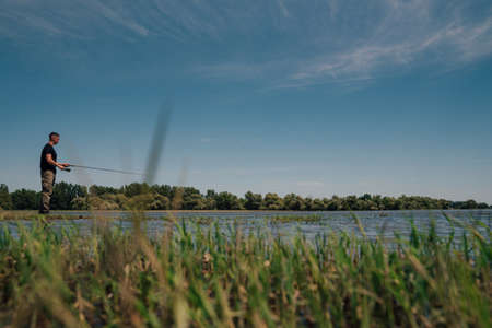 Fishing in river.Portrait of a fisherman with a fishing rod.A fisherman with a fishing rod on the...
