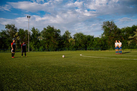 Soccer player kicks the ball.Soccer player takes the free-kick.Football player kicks the ball on the...