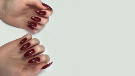 Hands of a woman with red manicure on nails