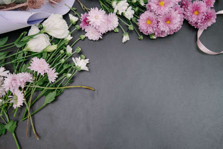 Florist equipment with flowers on wooden background, top view. Florist workplace: flowers and accessoriesの写真素材