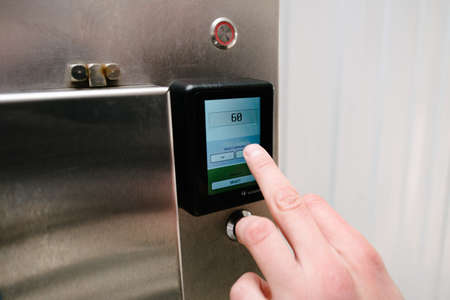 contactless payment by card in a self-service car wash. A person applies a card to the payment...
