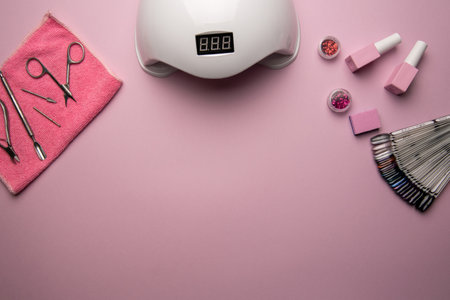 Set of manicure tools and accessories on a pink background, flat lay. Top view of manicure and pedicure equipment on pink backgroundの写真素材