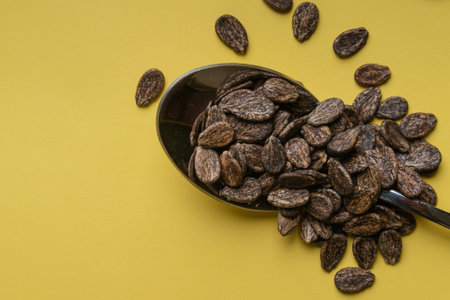 Watermelon seeds in on a yellow background, top view.の写真素材